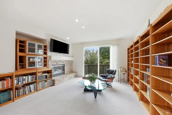 a living room with furniture a fireplace and a flat screen tv