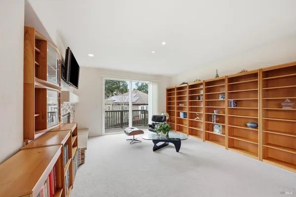 a view of a livingroom with furniture and floor to ceiling window