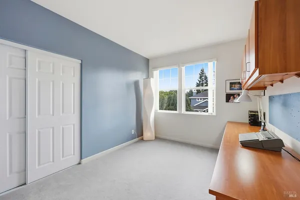 a view of a bedroom with furniture and a window