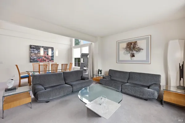 a living room with furniture a couch and a window