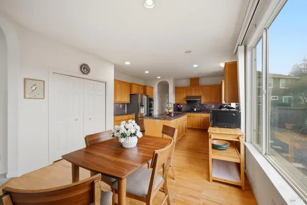 a view of a dining room with furniture a chandelier and wooden floor