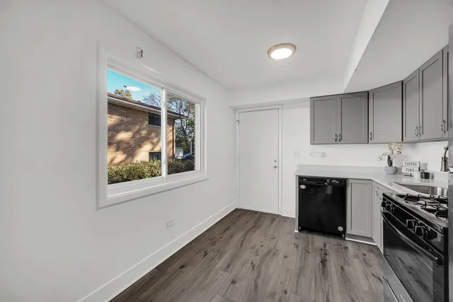 a kitchen with stainless steel appliances a stove top oven sink and cabinets