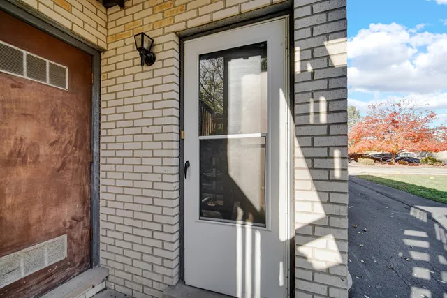 a view of a balcony with wooden floor and fence
