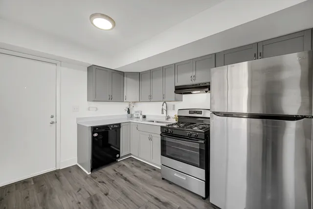 a kitchen with a refrigerator stove and white cabinets
