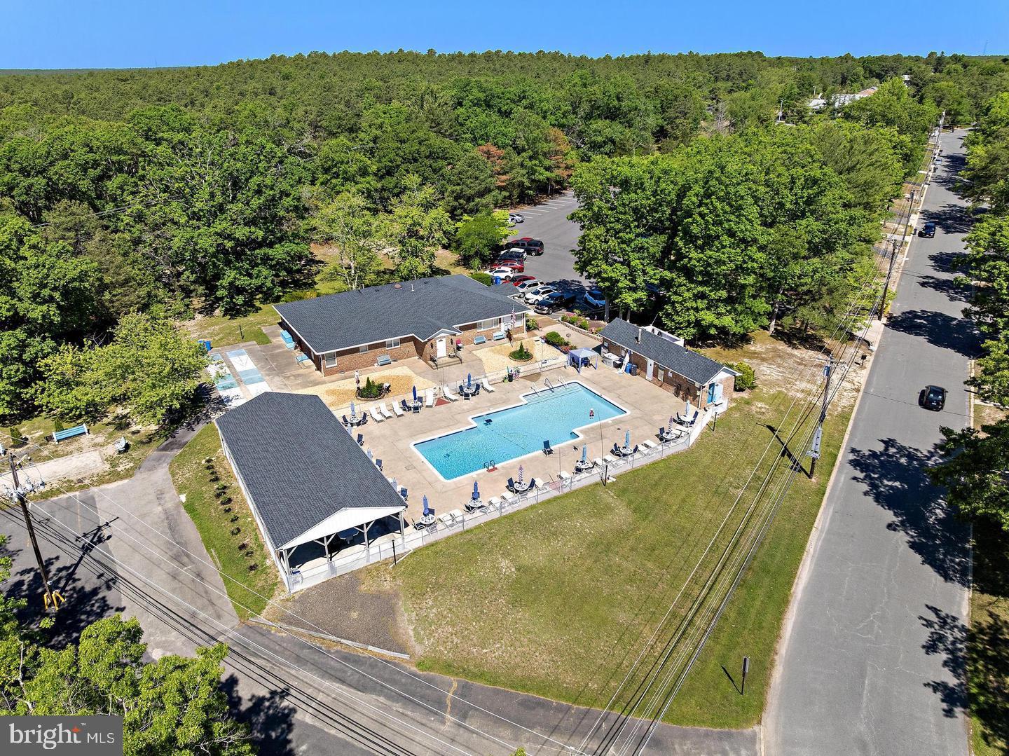 55 Sycamore Access Road Manahawkin, NJ 08050 - Photo 22 of 45 Serene poolside retreat in nature.