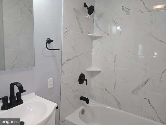 a bathroom with a sink a mirror and shower