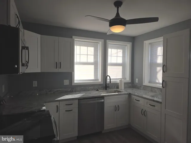 a kitchen with a sink and cabinets