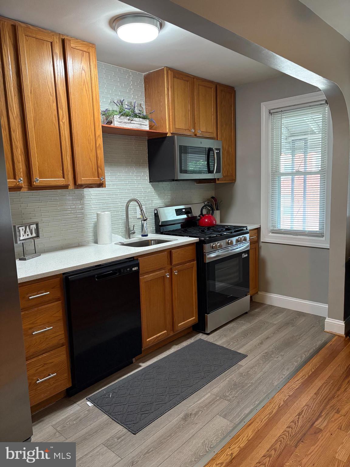 3541 Benzinger Road Baltimore, MD 21229 - Photo 11 of 33 a kitchen with stainless steel appliances granite countertop a stove a sink and a microwave