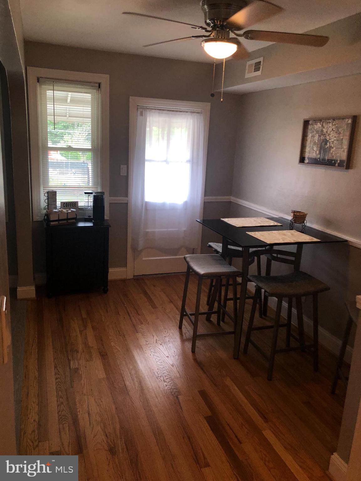 3541 Benzinger Road Baltimore, MD 21229 - Photo 12 of 33 a view of a dining room with furniture window and wooden floor