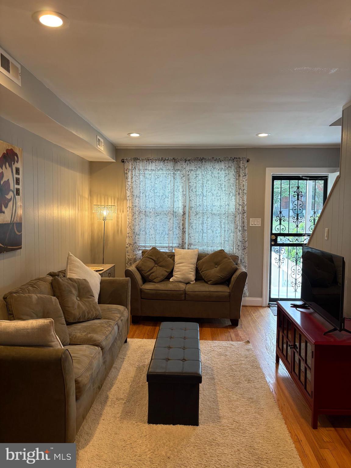 3541 Benzinger Road Baltimore, MD 21229 - Photo 20 of 33 a living room with furniture and a flat screen tv