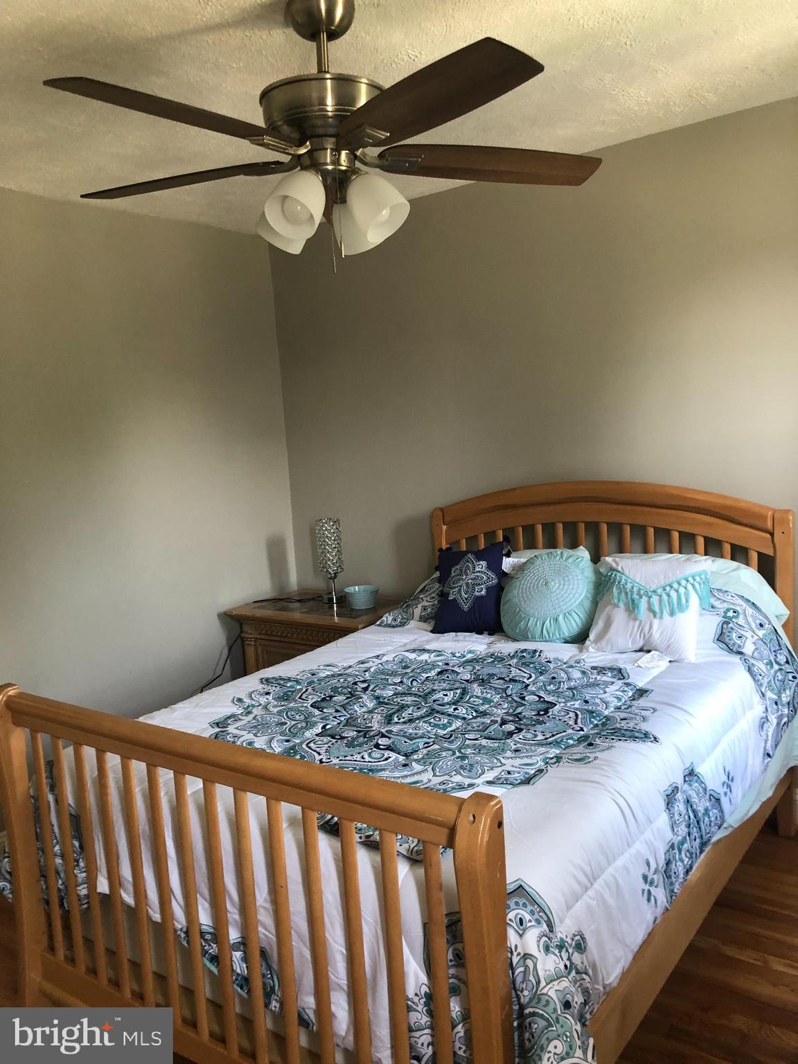 3541 Benzinger Road Baltimore, MD 21229 - Photo 22 of 33 a bedroom with a bed and ceiling fan