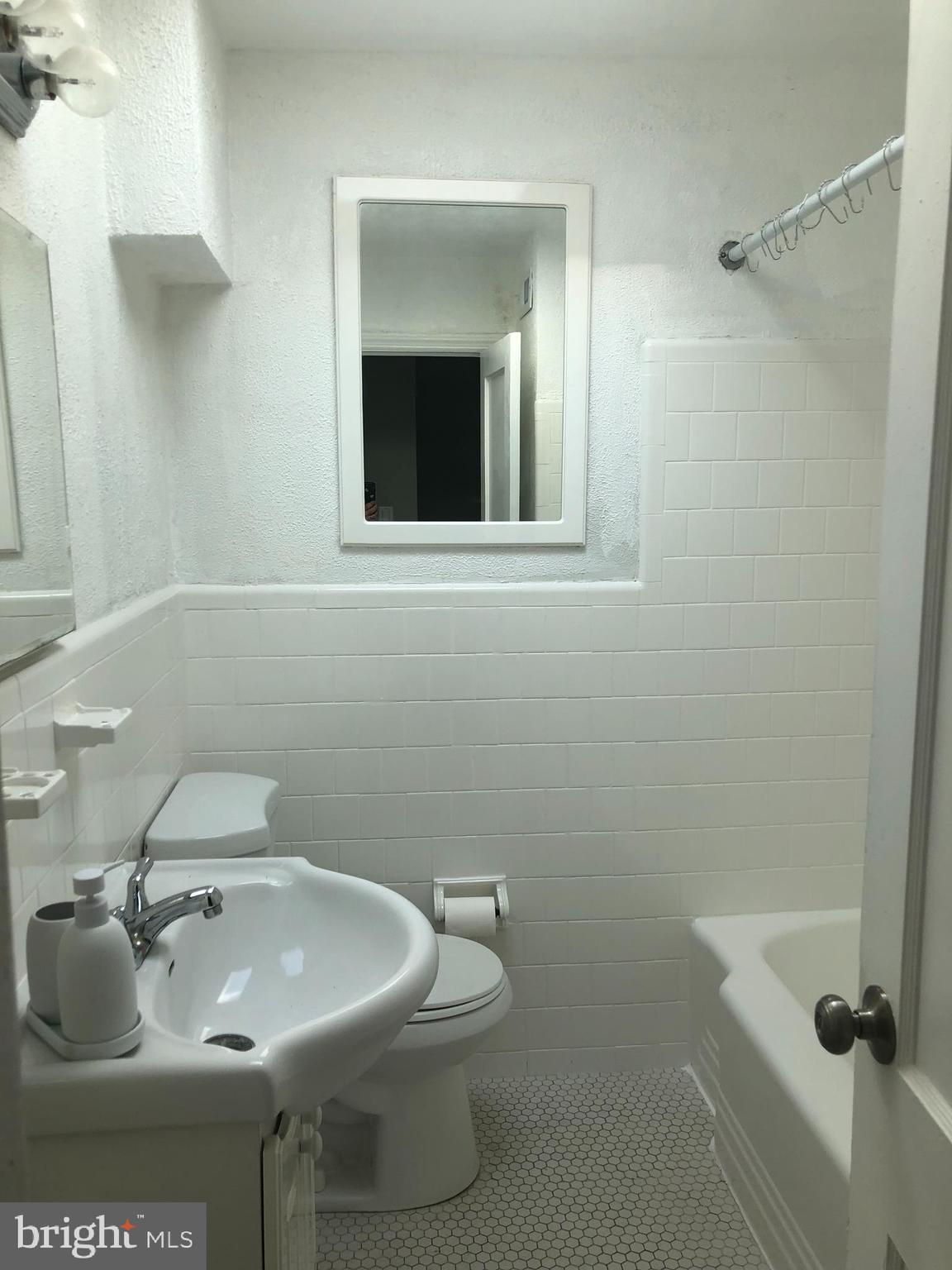 3541 Benzinger Road Baltimore, MD 21229 - Photo 25 of 33 a bathroom with a sink toilet and shower