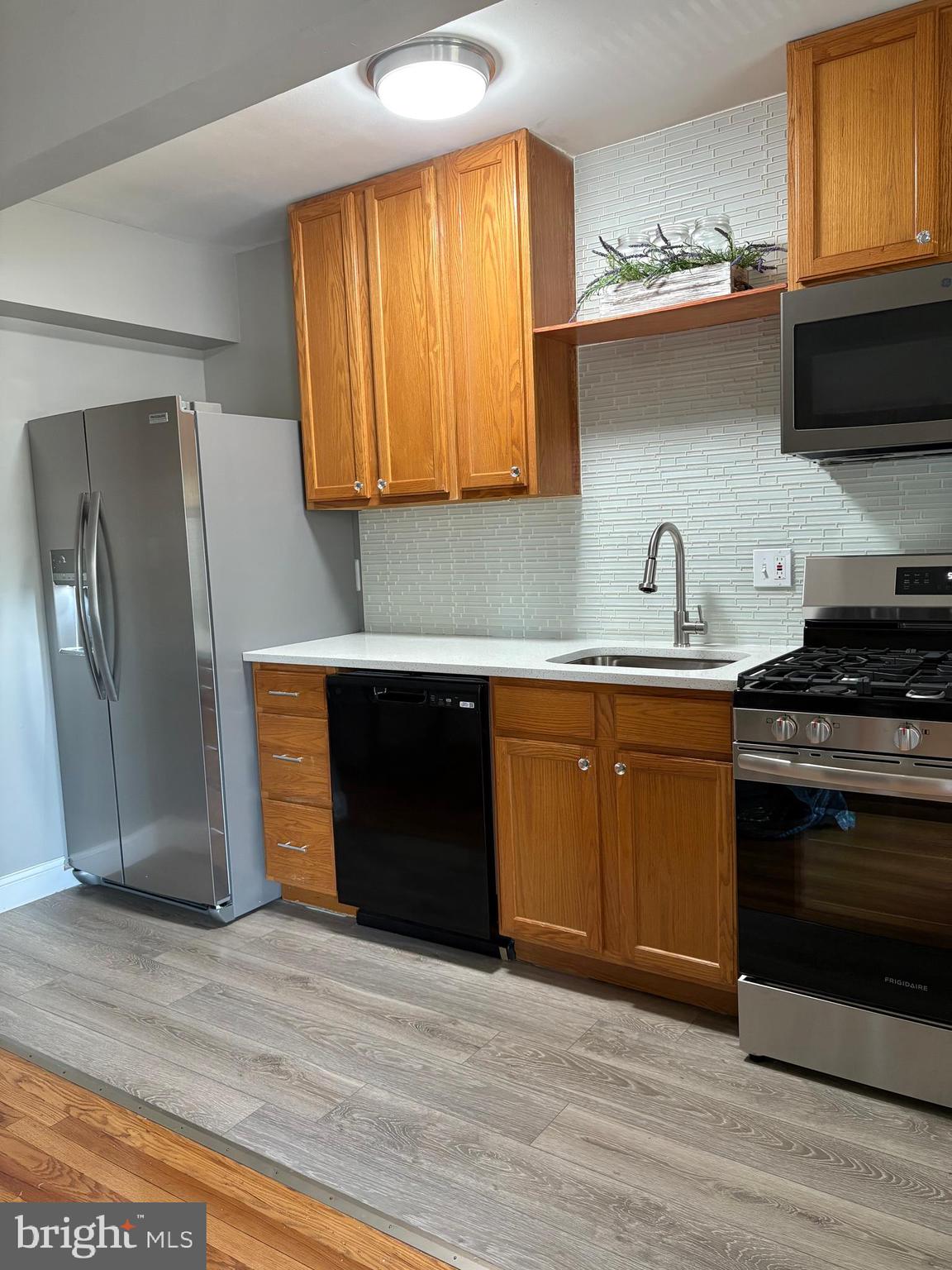3541 Benzinger Road Baltimore, MD 21229 - Photo 6 of 33 a kitchen with a sink and a refrigerator