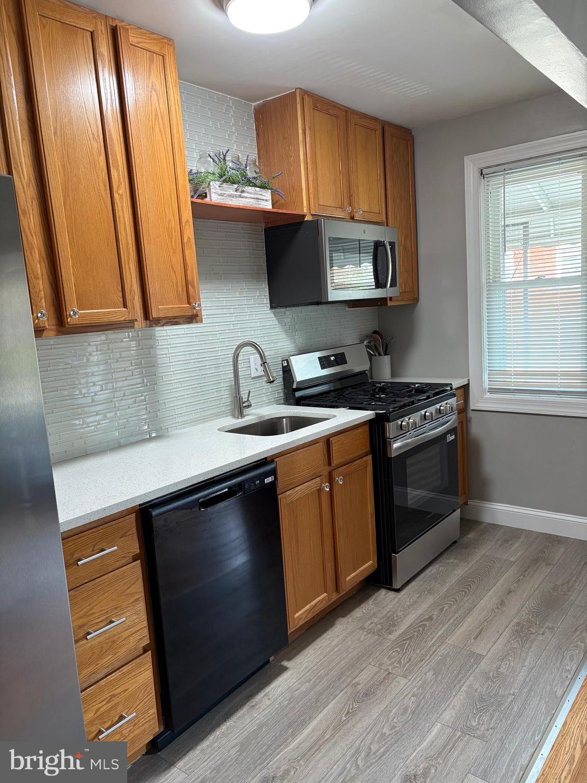 3541 Benzinger Road Baltimore, MD 21229 - Photo 7 of 33 a kitchen with stainless steel appliances granite countertop a sink stove and cabinets