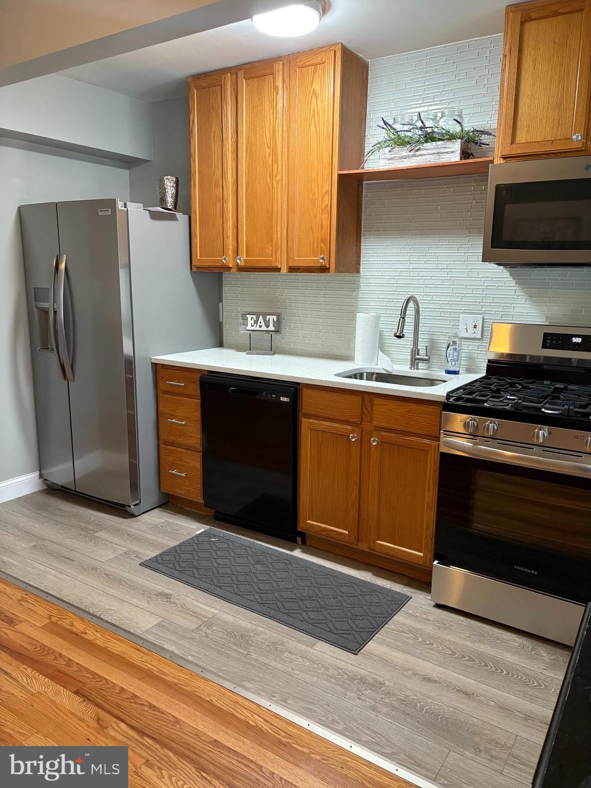 3541 Benzinger Road Baltimore, MD 21229 - Photo 9 of 33 a kitchen with stainless steel appliances granite countertop a stove a sink and a refrigerator