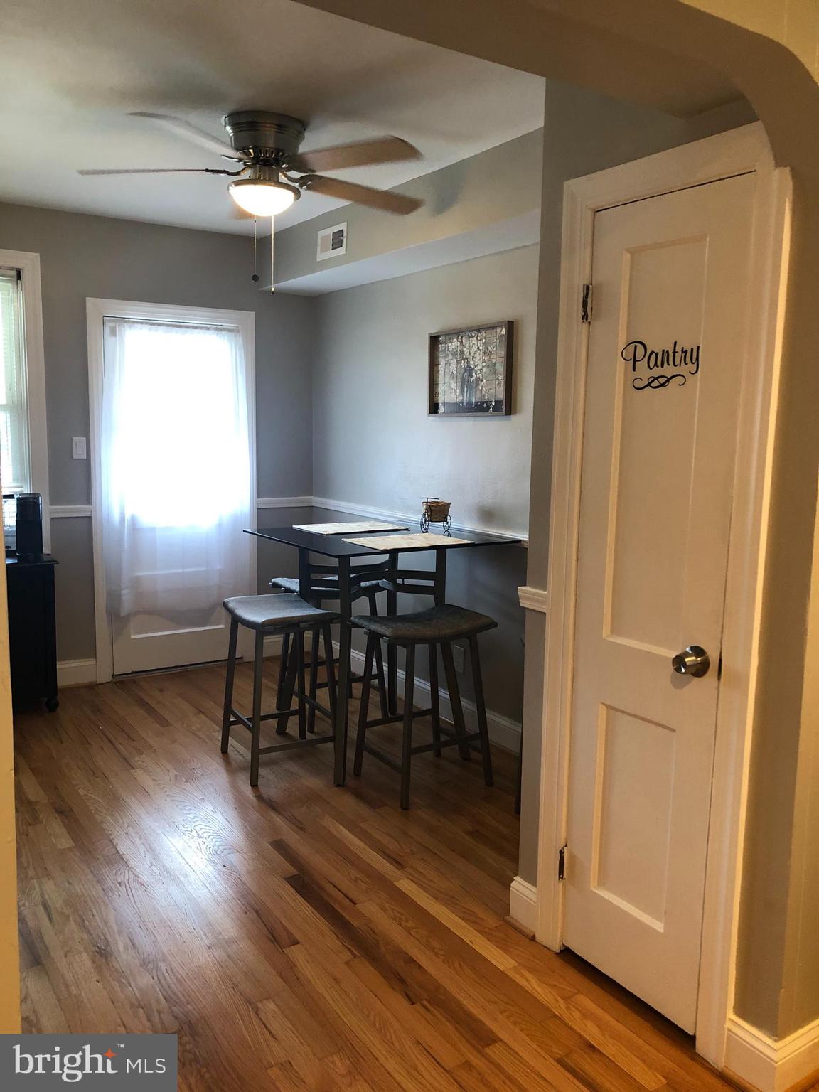 3541 Benzinger Road Baltimore, MD 21229 - Photo 10 of 33 a view of a dining room with furniture window and wooden floor