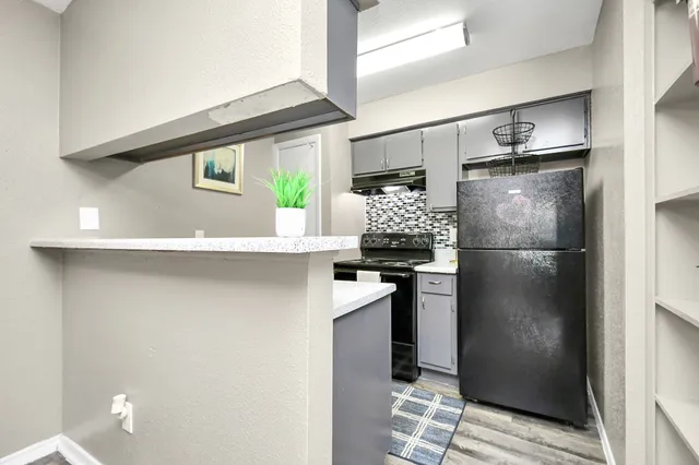 a kitchen with stainless steel appliances a refrigerator and a stove