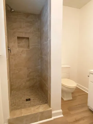 a bathroom with a toilet and a shower