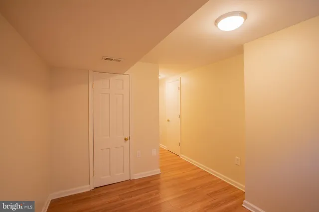 a view of a room with wooden floor
