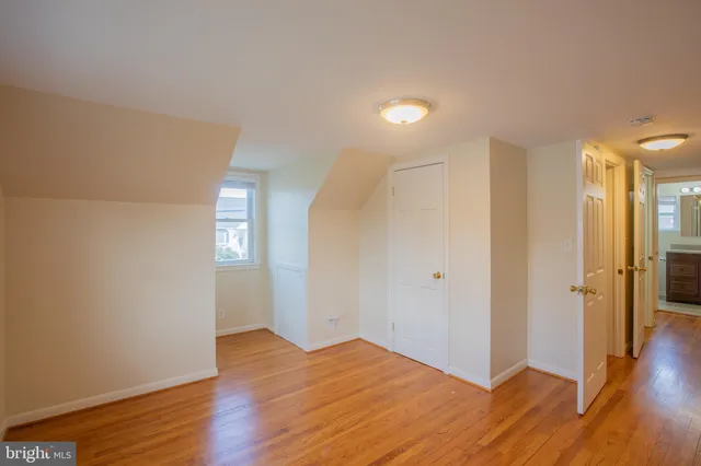 a view of hallway with wooden floor