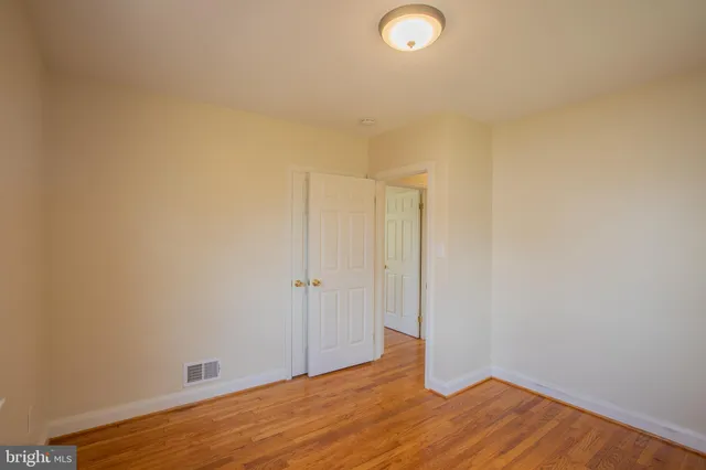 a view of a room with wooden floor