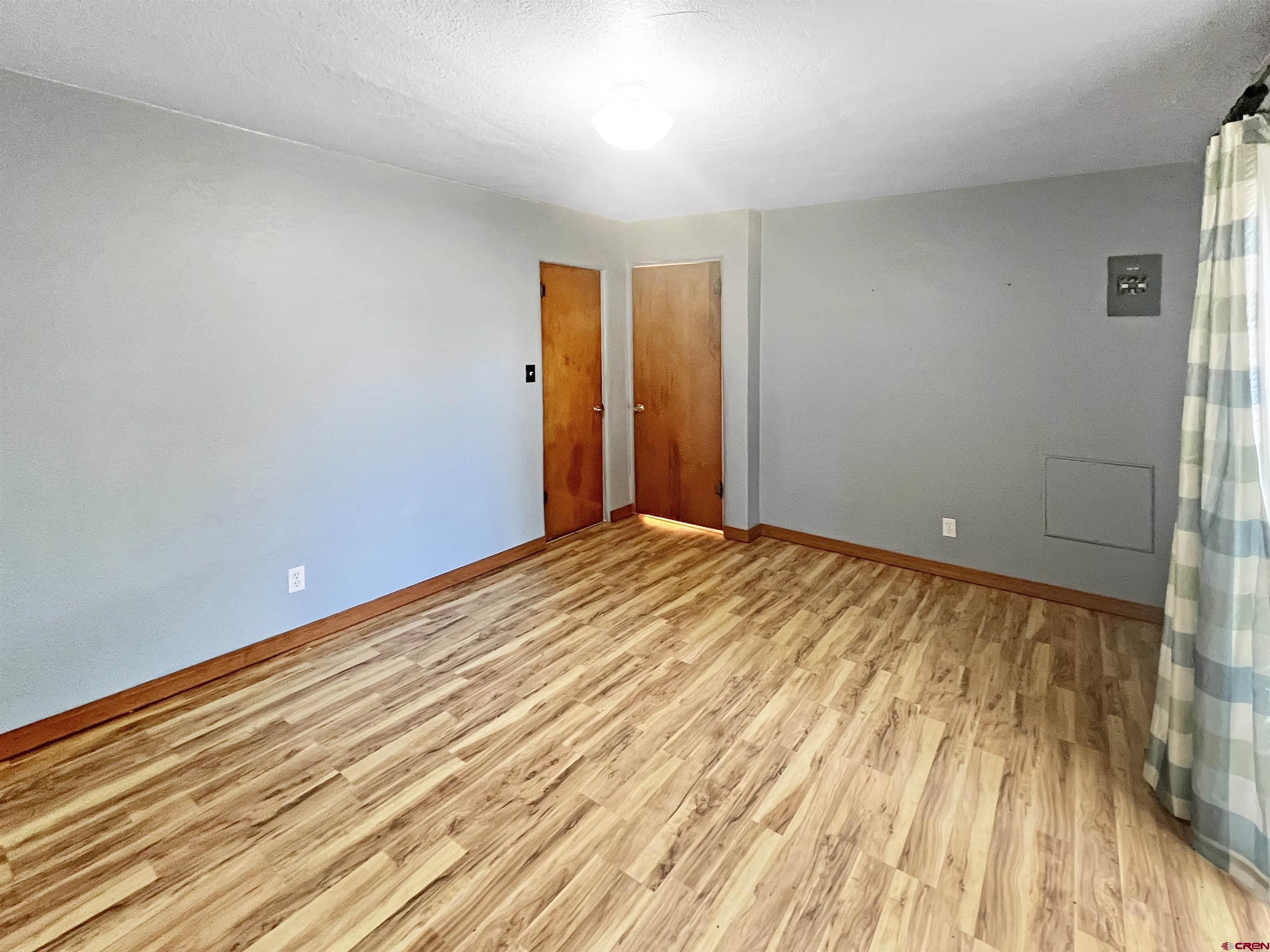 112 North Adams Street Cortez, CO 81321 - Photo 12 of 20 a view of a room with wooden floor