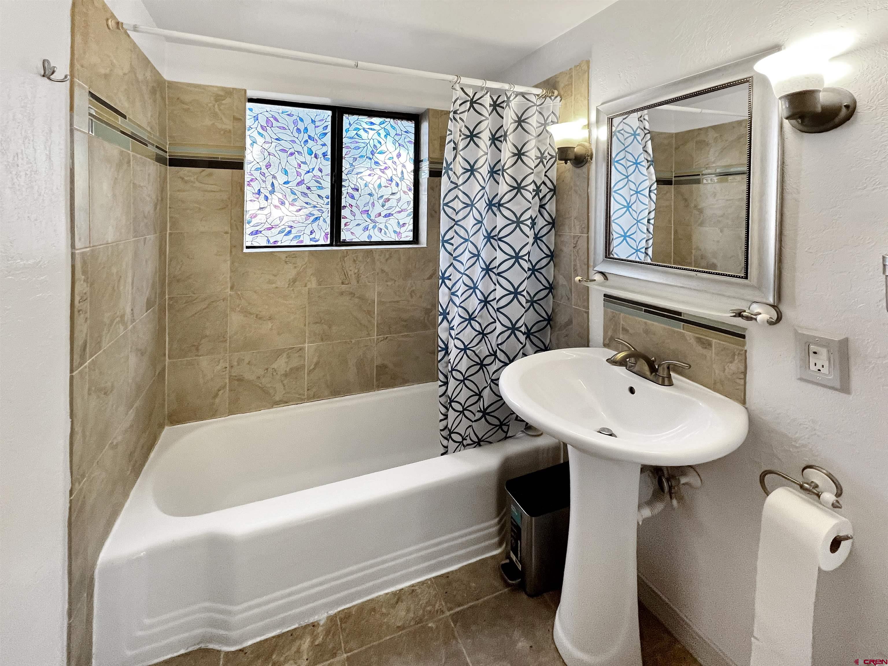 112 North Adams Street Cortez, CO 81321 - Photo 13 of 20 a bathroom with a sink a toilet and shower