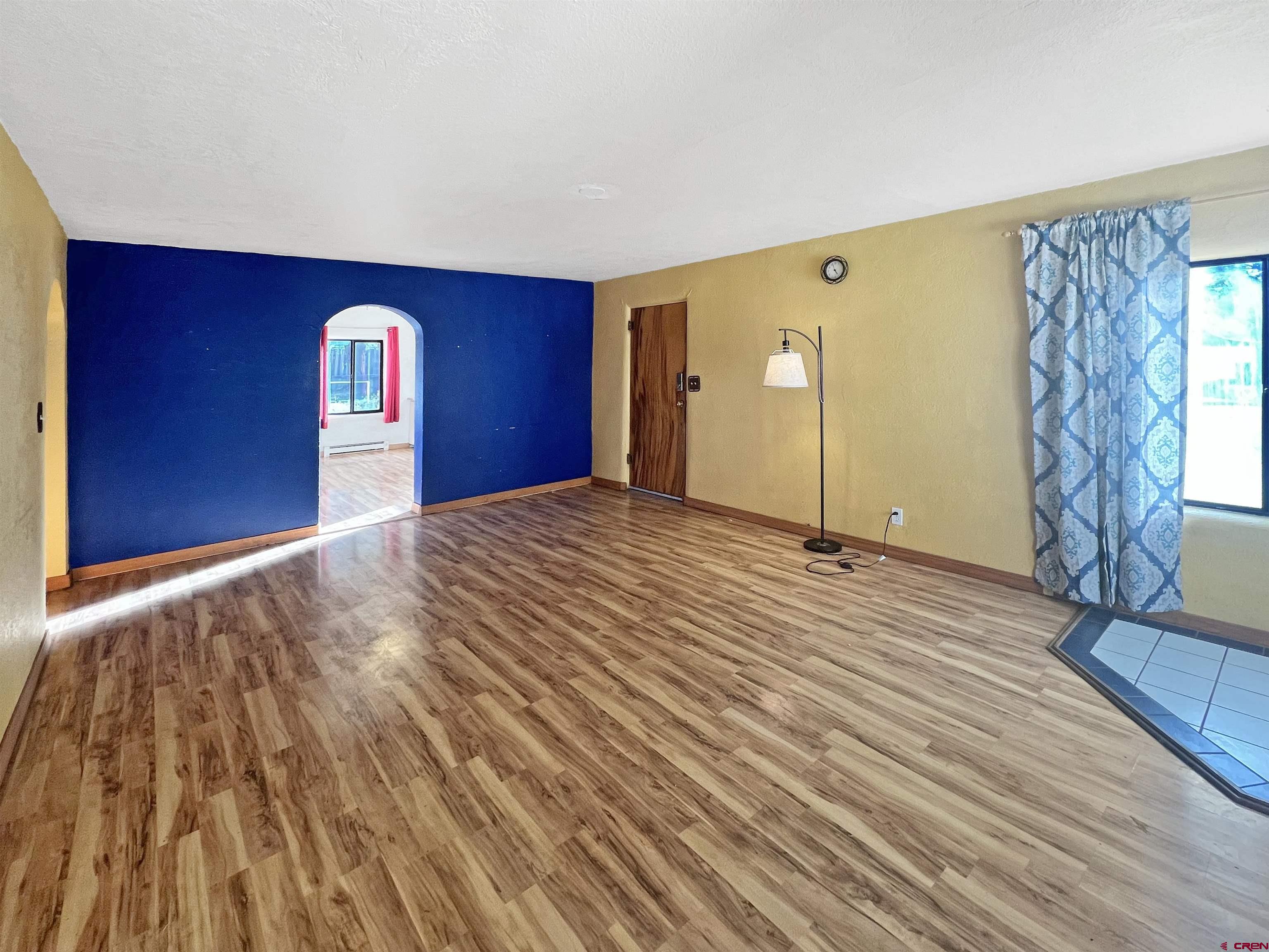 112 North Adams Street Cortez, CO 81321 - Photo 2 of 20 a view of a livingroom with wooden floor and window