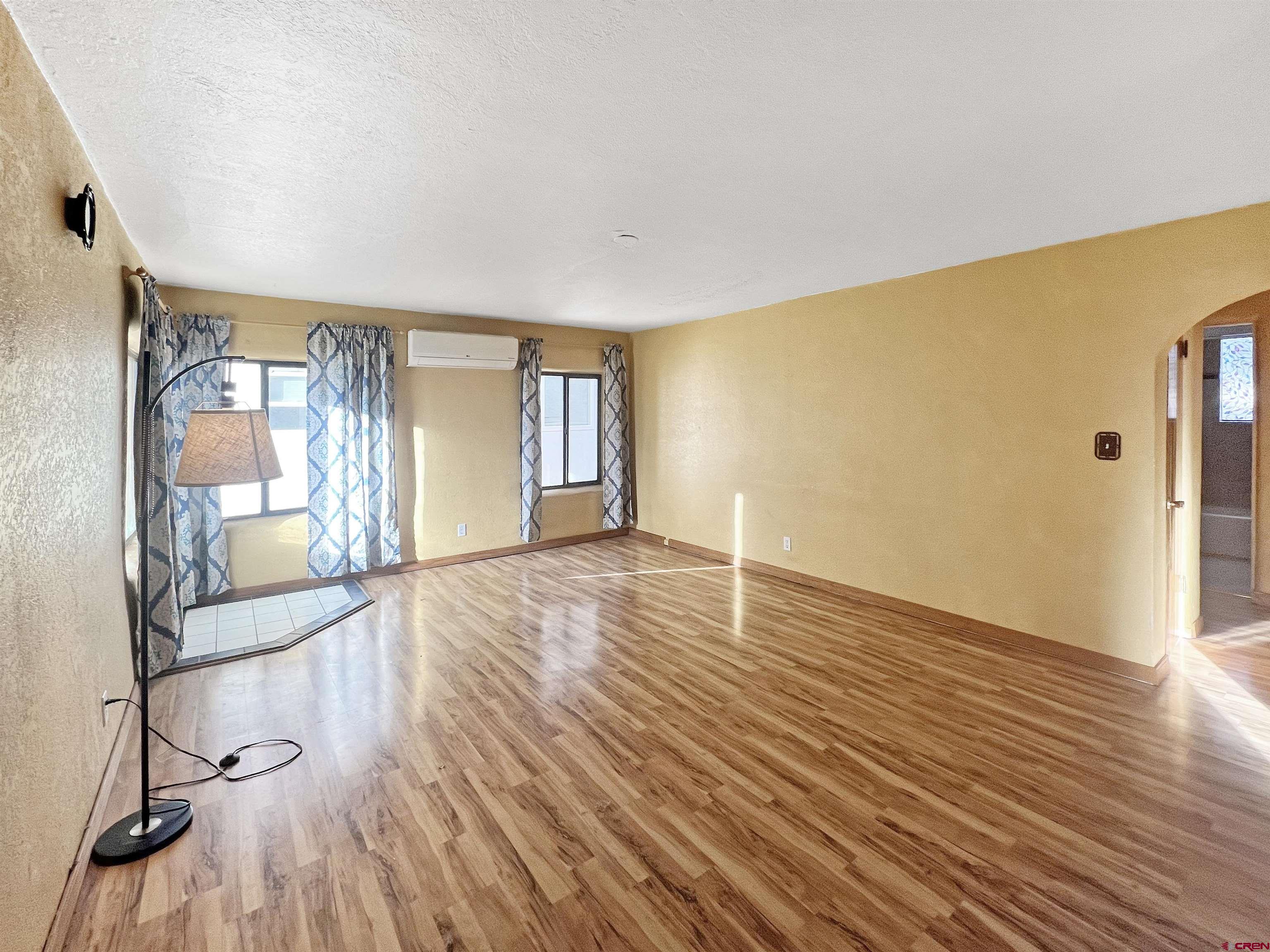 112 North Adams Street Cortez, CO 81321 - Photo 4 of 20 a view of empty room with wooden floor and fan