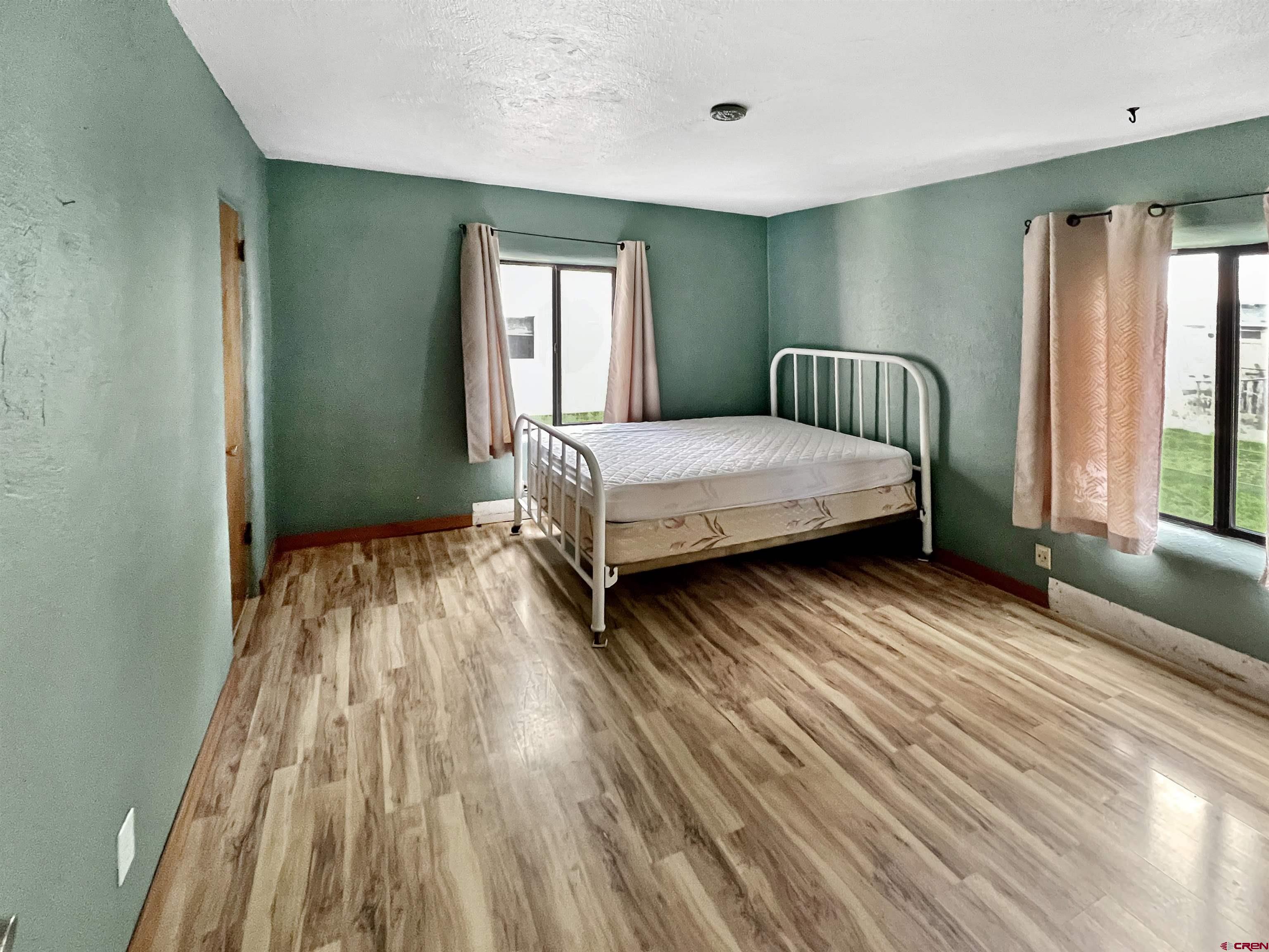 112 North Adams Street Cortez, CO 81321 - Photo 8 of 20 a bedroom with a bed and window