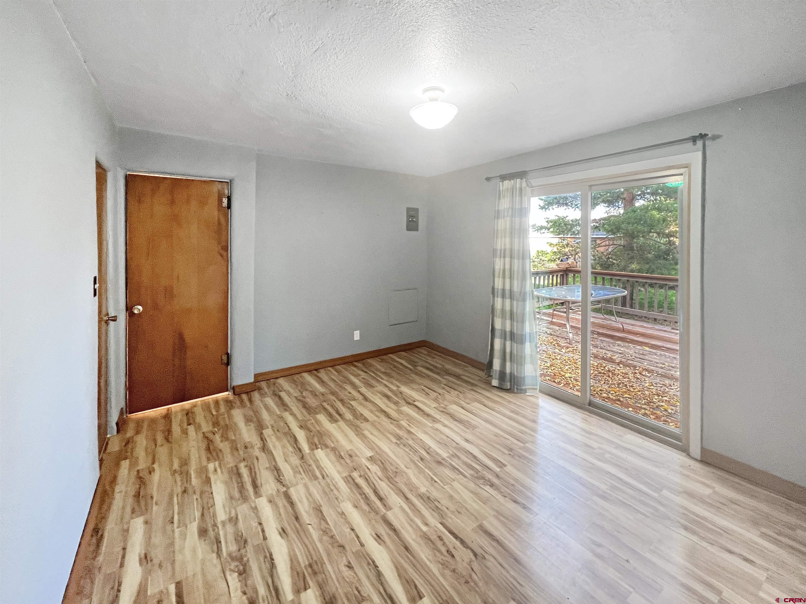 112 North Adams Street Cortez, CO 81321 - Photo 10 of 20 wooden floor in an empty room with a window