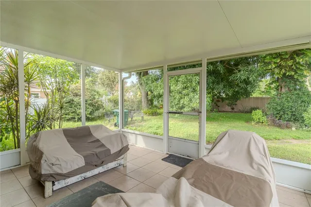 a living room with furniture and a floor to ceiling window