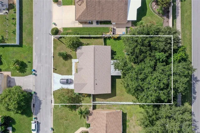 an aerial view of a house and tree