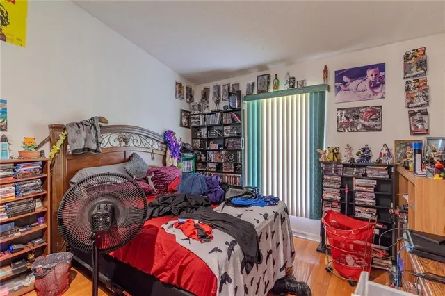 a bedroom with two beds and a book shelf