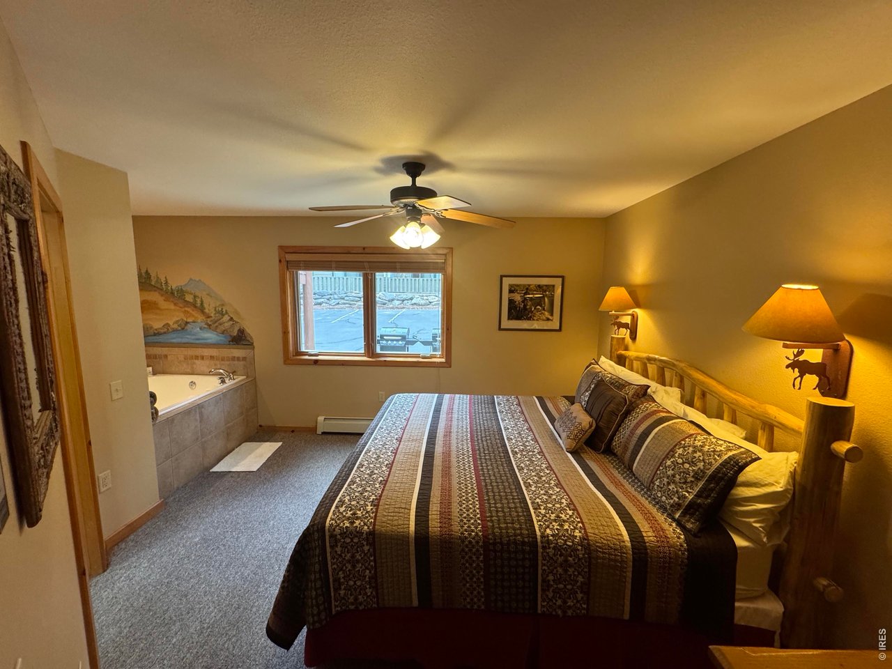 2100 Fall River Road, Unit 4 Estes Park, CO 80517 - Photo 13 of 28 a bedroom with a bed and a window