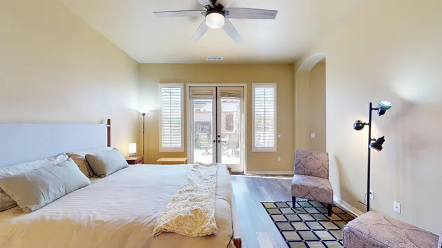 a bedroom with a bed and a chandelier