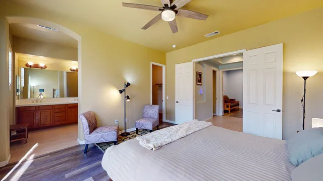 a bedroom with a bed and a chandelier