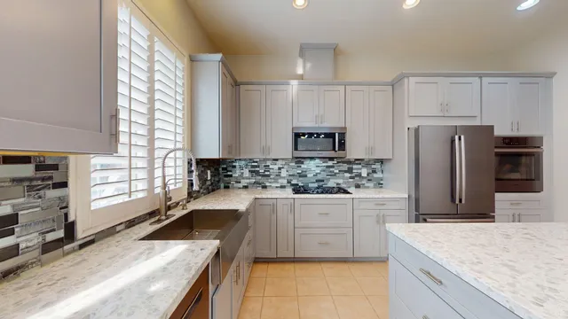 a kitchen with a stove a sink and a refrigerator