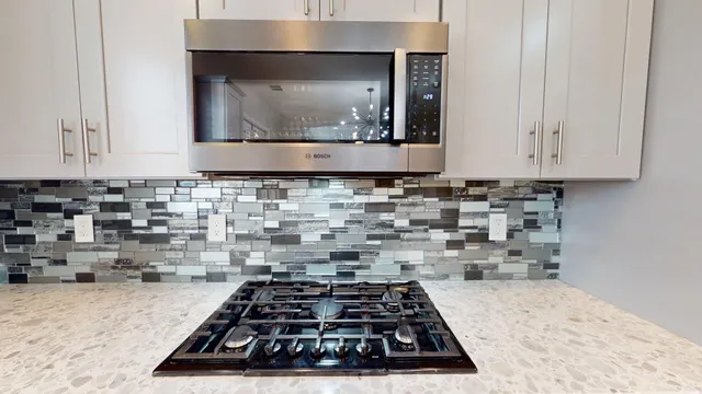 a room with a stove and cabinets