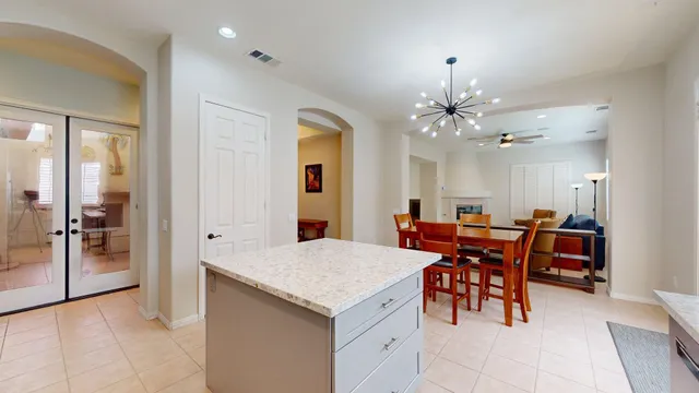 a view of a dining room with furniture and chandelier