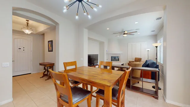 a kitchen with a dining table chairs stainless steel appliances and cabinets