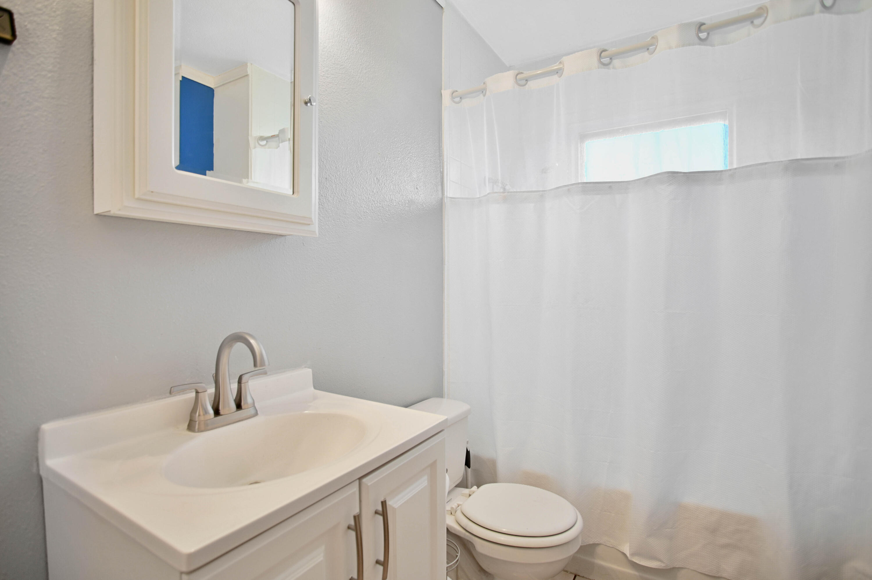 704 4th Street Smyer, TX 79367 - Photo 11 of 38 a bathroom with a sink a toilet and shower