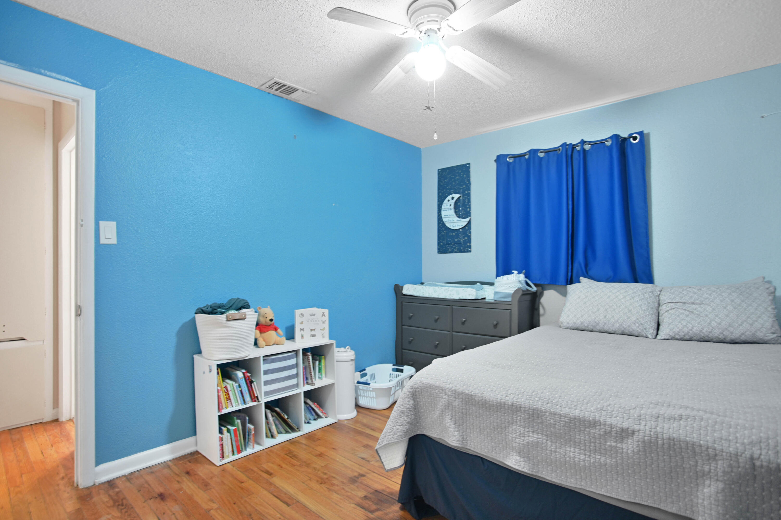 704 4th Street Smyer, TX 79367 - Photo 13 of 38 a bedroom with a bed and a bookshelf