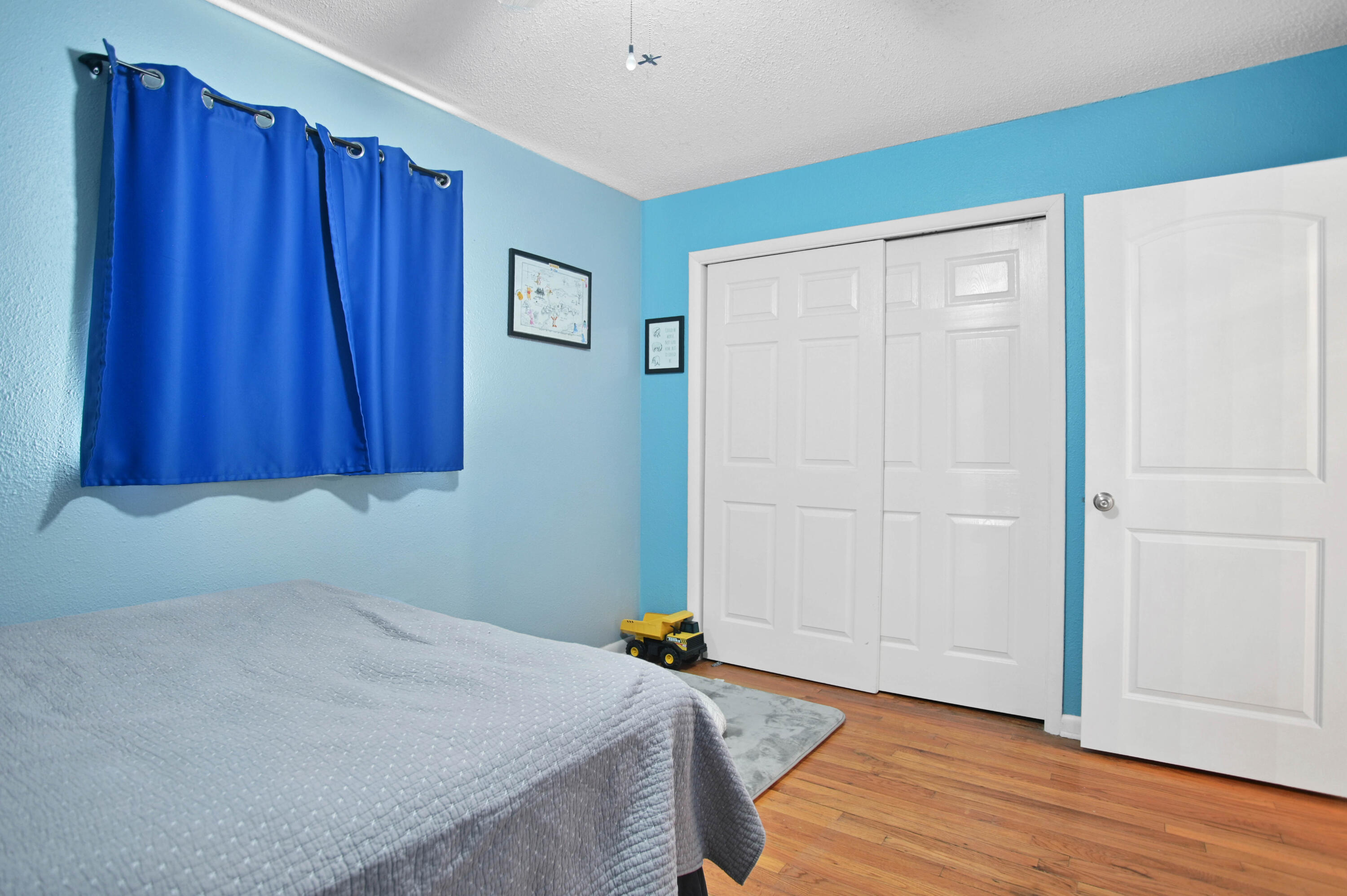 704 4th Street Smyer, TX 79367 - Photo 14 of 38 a room with a bed and wooden floor