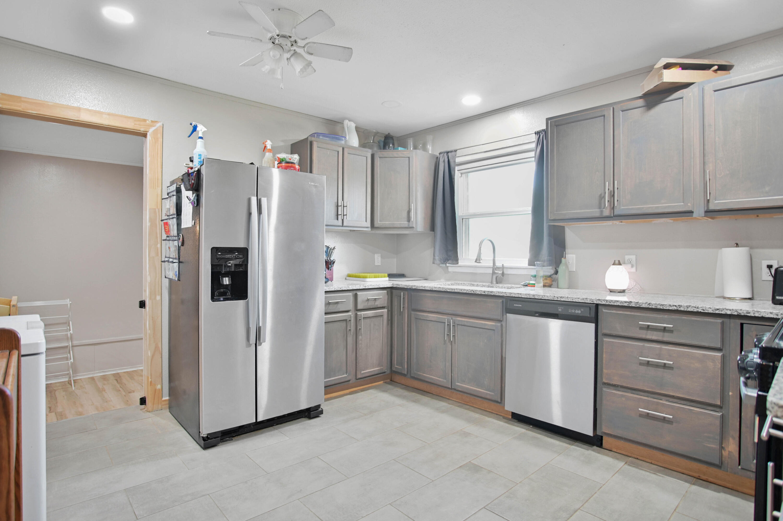 704 4th Street Smyer, TX 79367 - Photo 15 of 38 a kitchen with white cabinets and white appliances