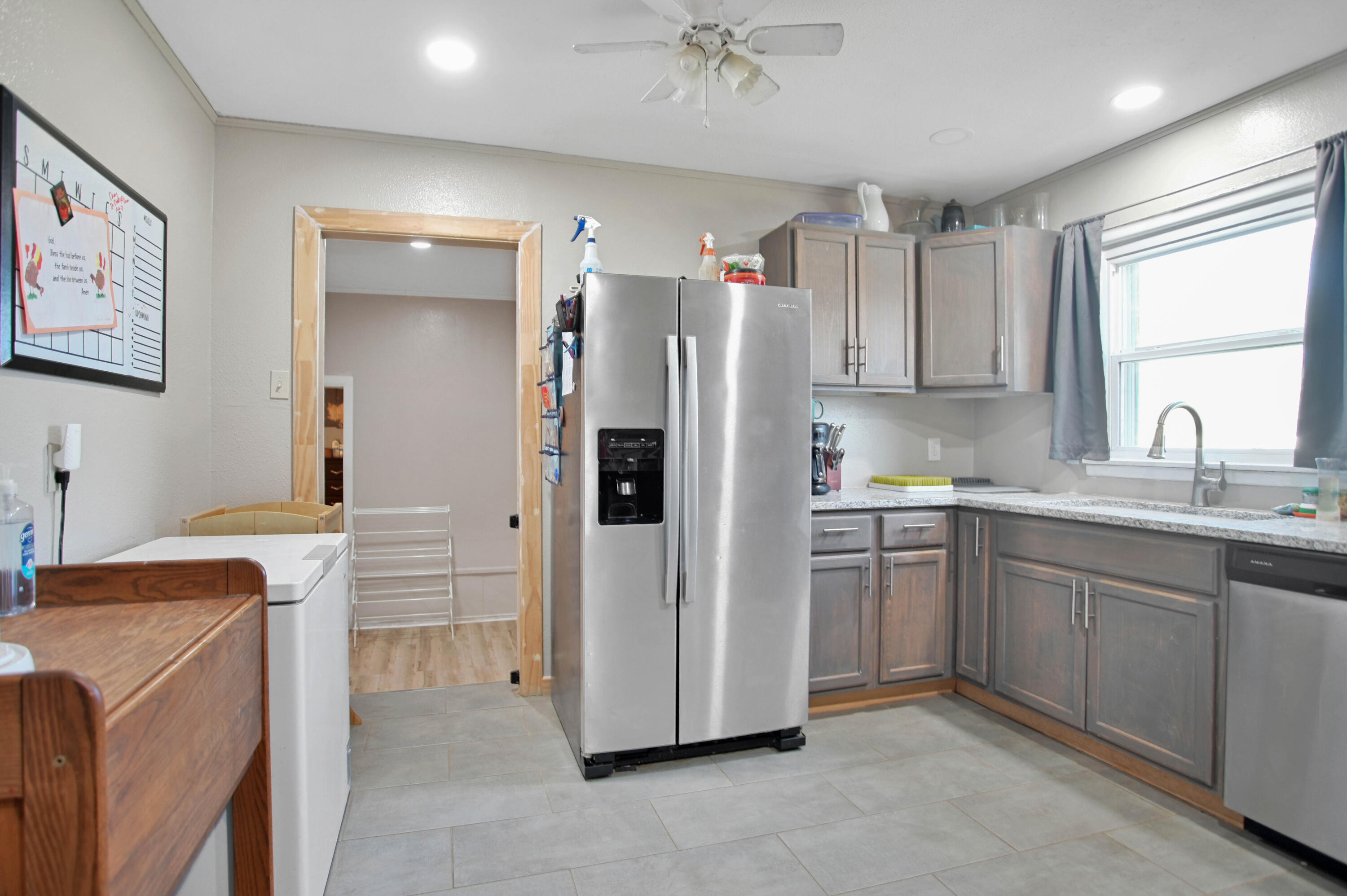 704 4th Street Smyer, TX 79367 - Photo 16 of 38 a kitchen with stainless steel appliances granite countertop a refrigerator sink and stove
