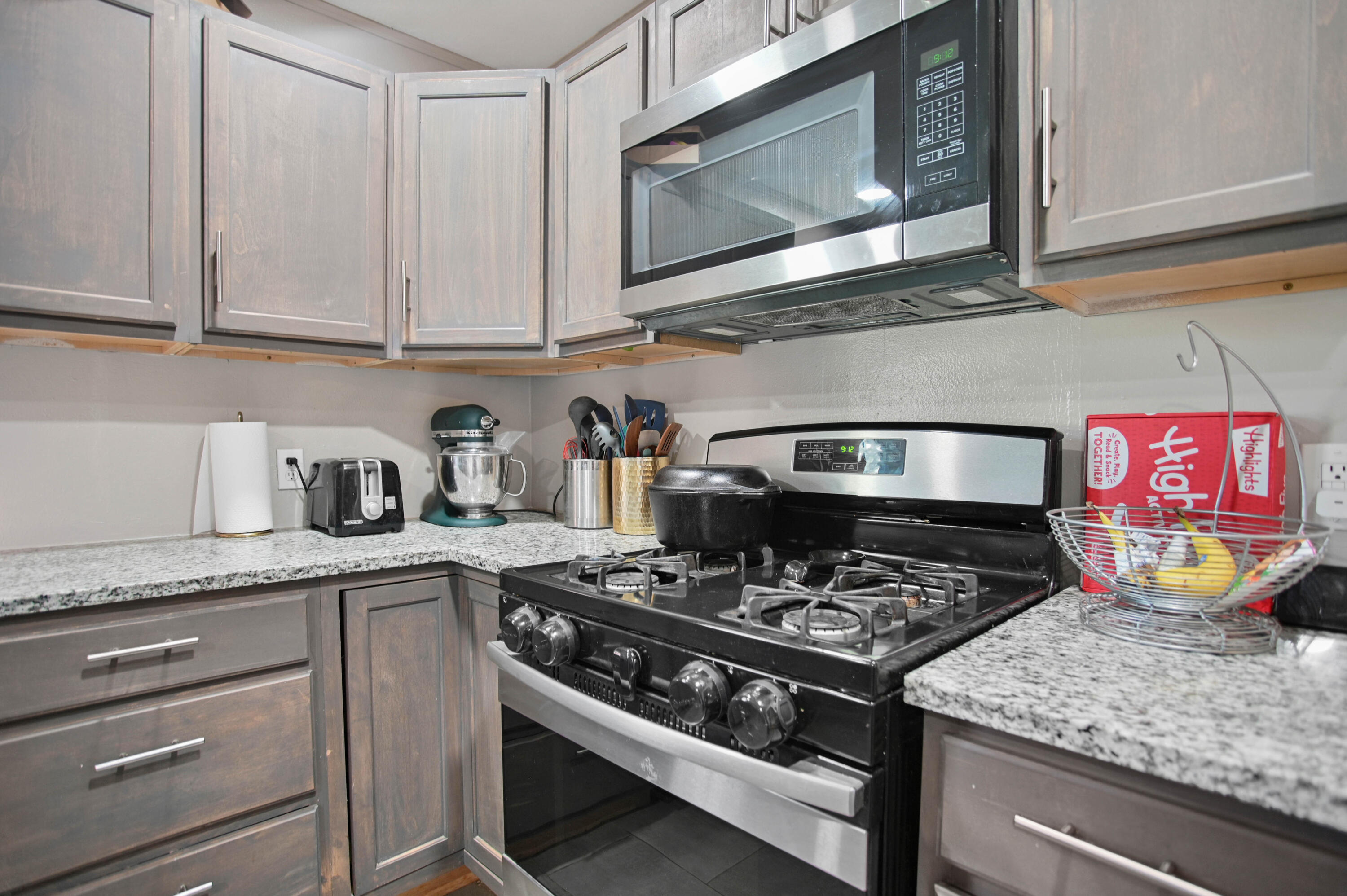 704 4th Street Smyer, TX 79367 - Photo 18 of 38 a kitchen with stainless steel appliances granite countertop a stove and a microwave