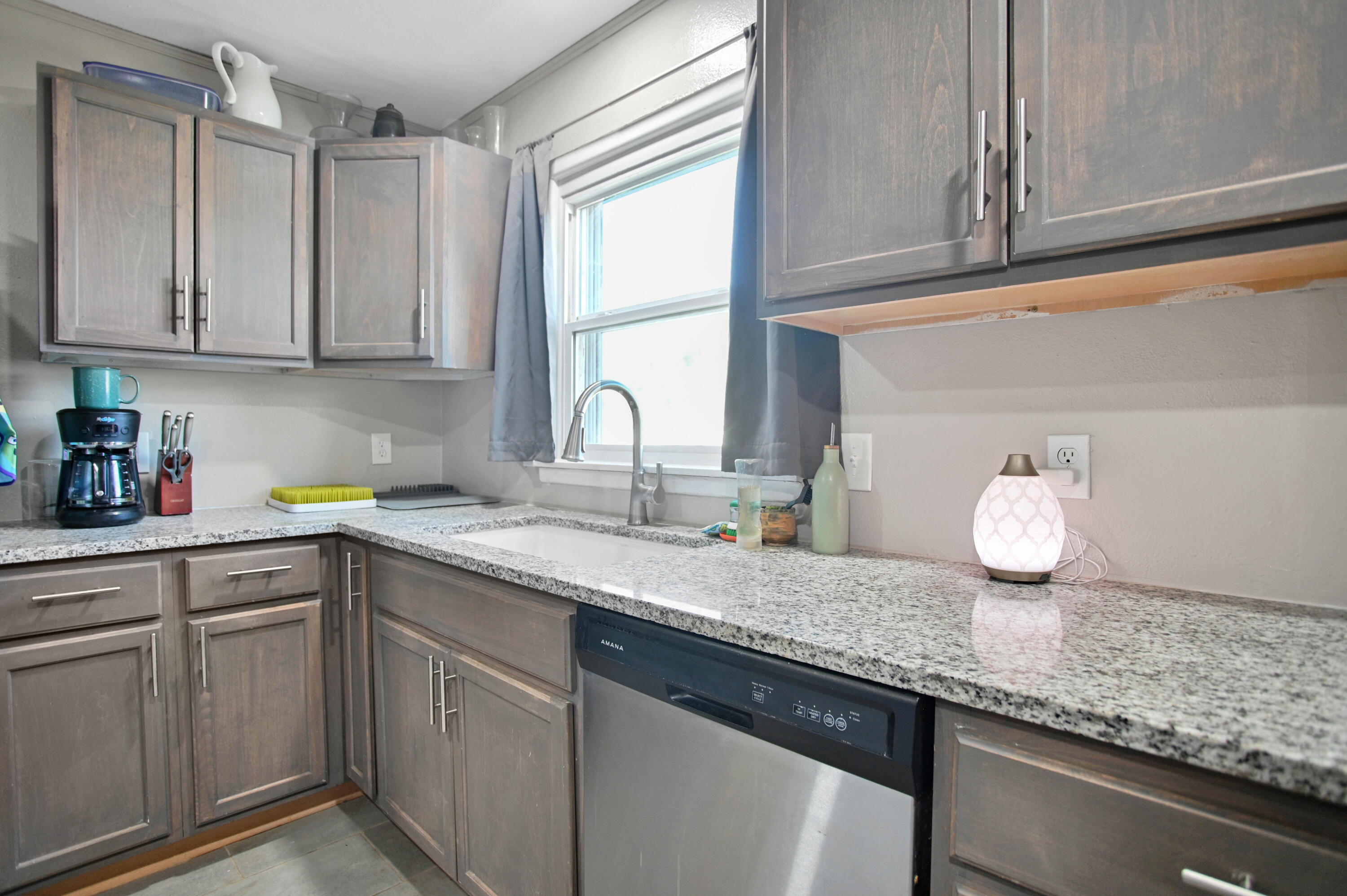 704 4th Street Smyer, TX 79367 - Photo 19 of 38 a kitchen with granite countertop stainless steel appliances sink and cabinets