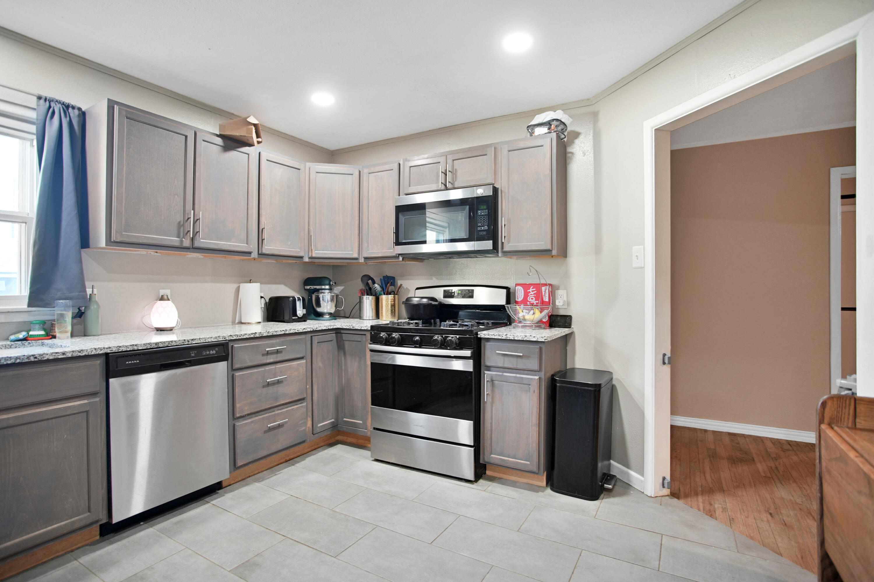 704 4th Street Smyer, TX 79367 - Photo 21 of 38 a kitchen with stainless steel appliances granite countertop a stove sink and cabinets