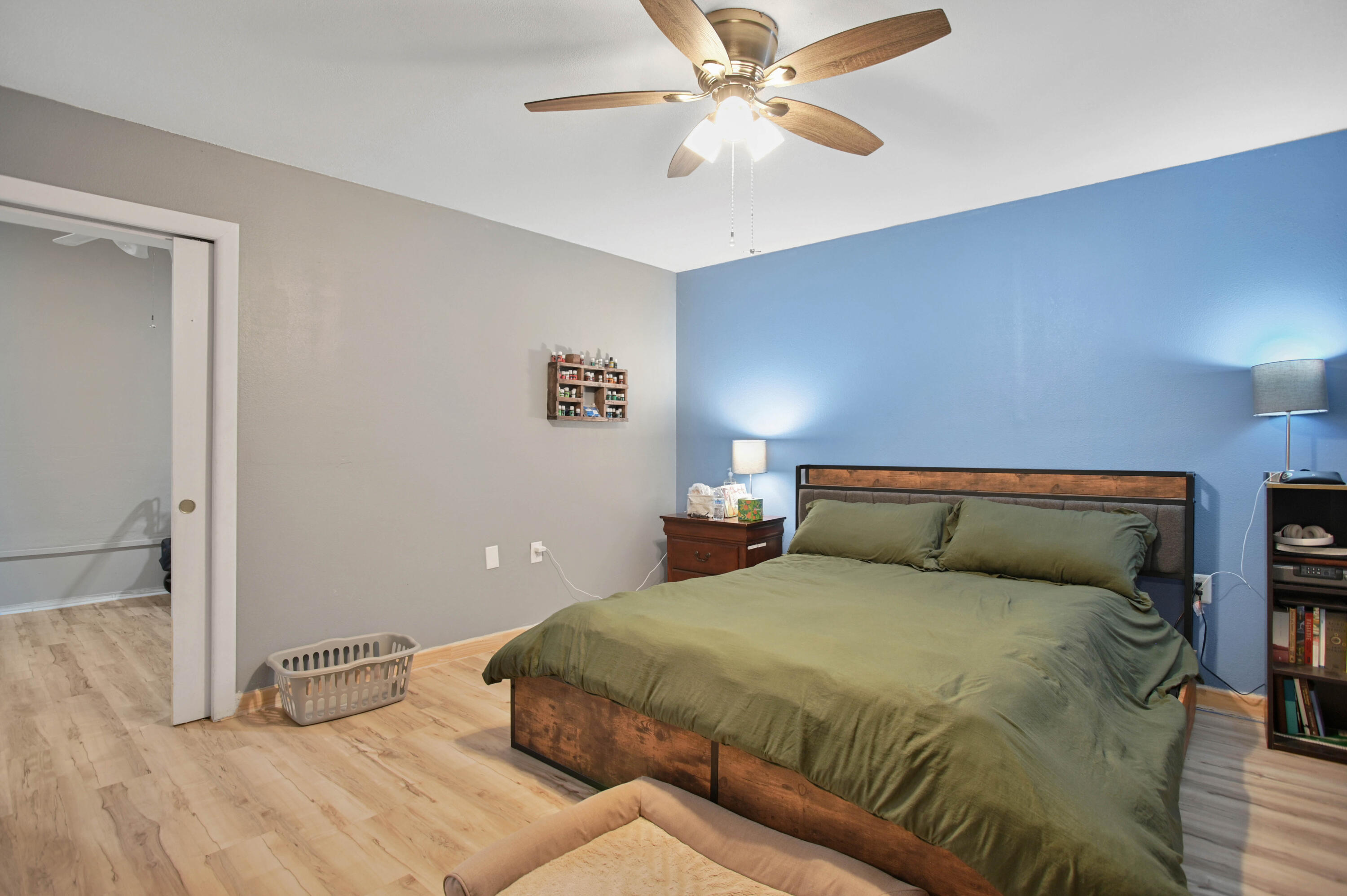 704 4th Street Smyer, TX 79367 - Photo 29 of 38 a bedroom with a large bed and a chandelier